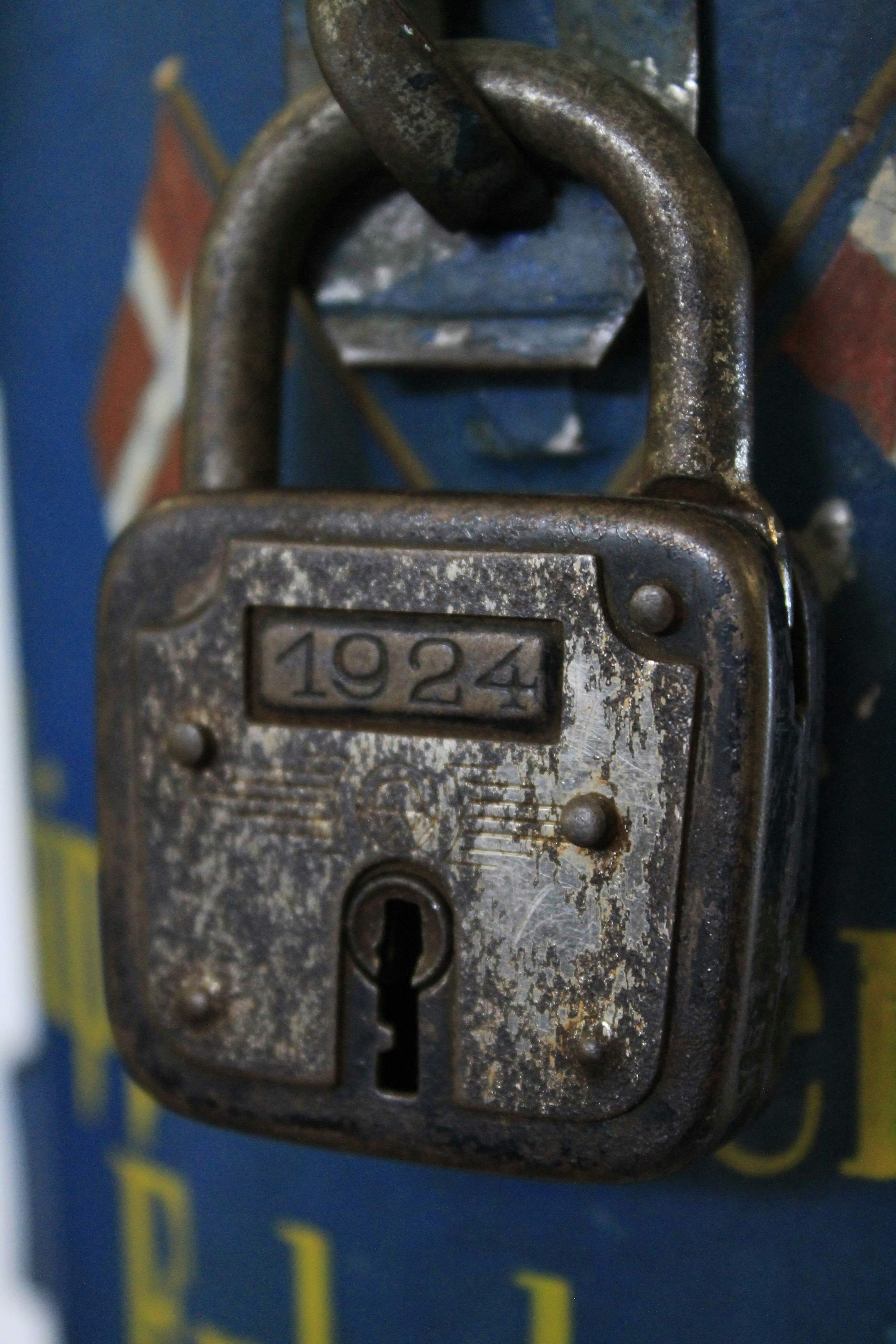 an old padlock on a door with a chain